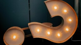 Lit up question mark. Open-ended questions in leadership